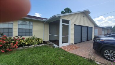 View of side of home with a garage and a sunroom