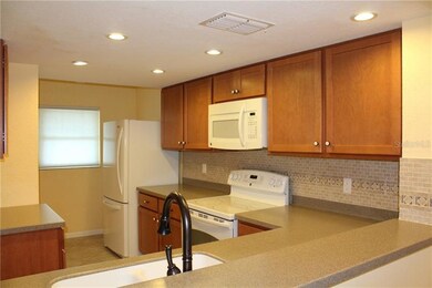 Kitchen features attractive and neutral backsplash