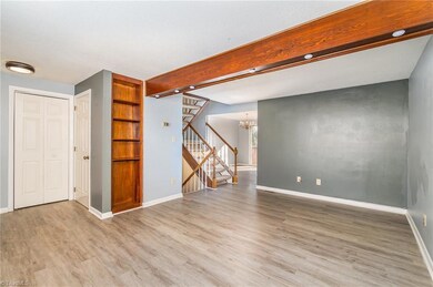 Living Room with built in shelving and closet space for storage.