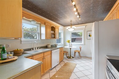 Great eat in kitchen with pressed ceiling tiles + new dishwasher & range.