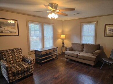 Living room with ornamental molding, ceiling fan, 