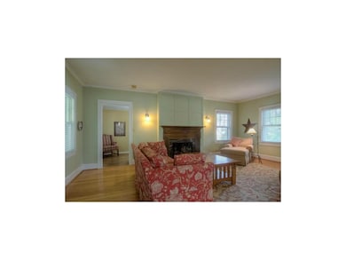 Living room with newer gas logs. Door on left lead