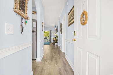 Hallway with light wood finished floors, baseboard