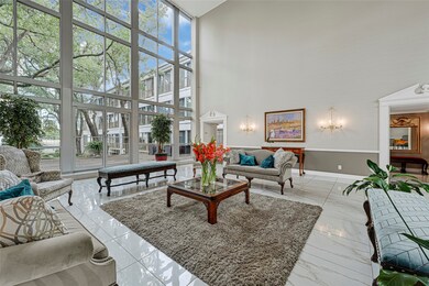 Expansive lounge with high ceilings and floor-to-ceiling windows, showcasing abundant natural light.