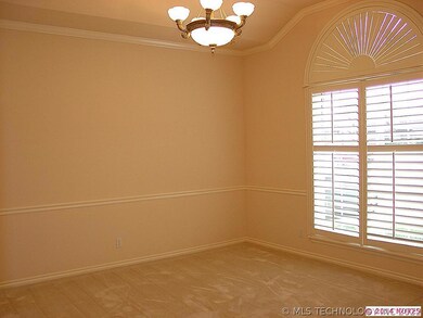 Elegant formal dining with vaulted ceiling, crown