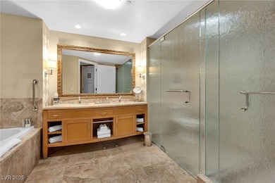 Bathroom with vanity, a stall shower, and a garden