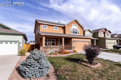 View of front of home with stucco siding, concrete driveway, stone siding, and covered porch
