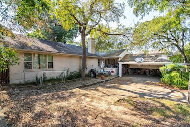 Ranch-style home with a chimney, an attached garag