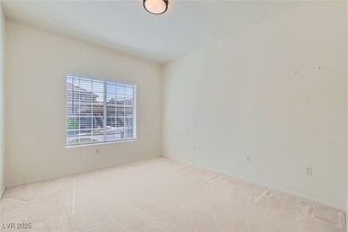 Carpeted spare room with baseboards