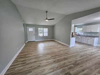 Unfurnished living room with lofted ceiling, sink,