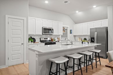 Kitchen in a Trinity Ranch Diamond Model in Elgin TX by Trophy Signature Homes