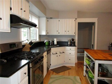 Kitchen features gas range,...