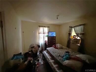 Bedroom featuring cooling unit and multiple window