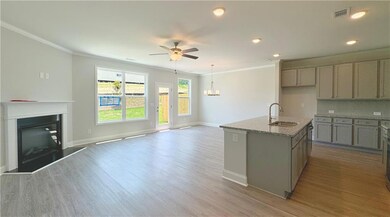 Kitchen featuring ornamental molding, a fireplace 