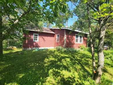 View of side of home featuring a lawn