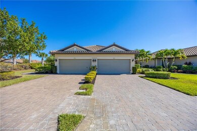 Single story home with stucco siding, decorative driveway, and a tile roof