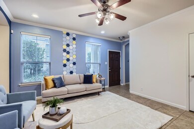 Living area with ceiling fan, arched walkways, or