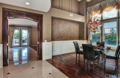 Warm and inviting dining room has soaring ceilings