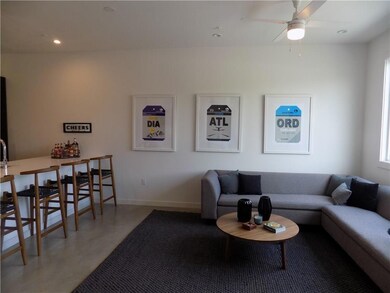 Living room with a ceiling fan, recessed lighting