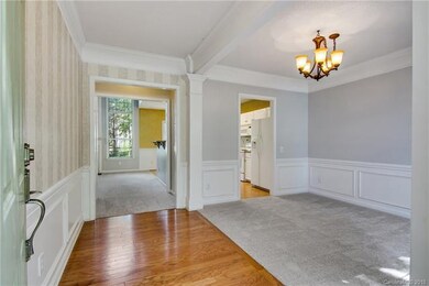 Wood floor entryway, with crown molding and wainsc