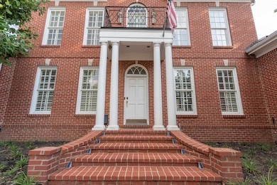 Property entrance featuring a balcony