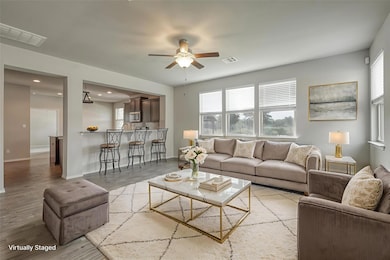 Living room featuring ceiling fan, wood finished 