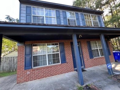 View of front of home with brick siding and covered porch