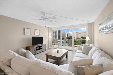 Living room with ceiling fan, a textured ceiling,