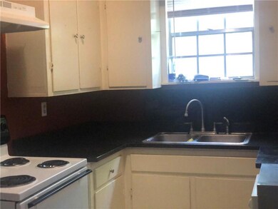 Kitchen featuring white range with electric stovet