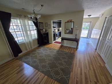 Entryway with a textured ceiling, visible vents, b