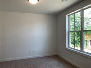 Unfurnished room with plenty of natural light and carpet floors