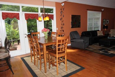 The dining area has doors that lead to the deck fo