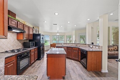 Kitchen featuring black appliances, a sink, a kit