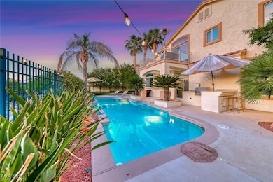 Pool at dusk featuring an outdoor bar and a patio