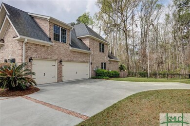 Three car garage with extra 2 car parking pad.
