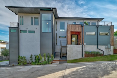View of front of property with a balcony and stuc