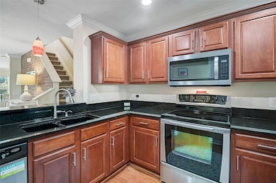 The kitchen includes a breakfast bar with granite countertops and stainless steel appliances, perfect for casual dining and entertaining.