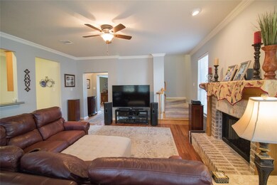 Living area with ceiling fan, visible vents, a br