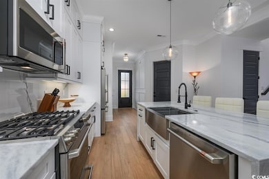 Kitchen featuring visible vents, crown molding, li