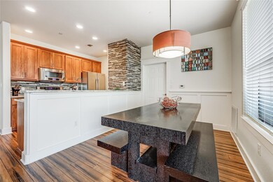 Kitchen with dark wood-style flooring, a decorati