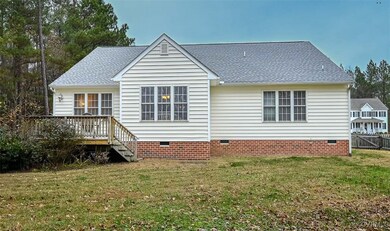 Back of house featuring a yard and a deck