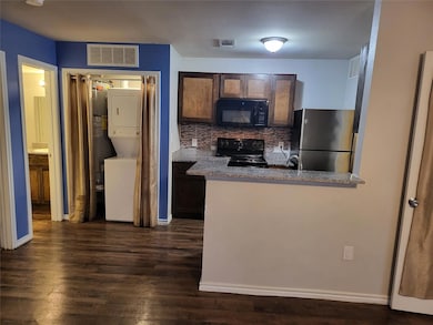 Kitchen with tasteful backsplash, dark wood-type f