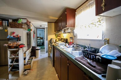 Kitchen featuring vaulted ceiling, sink, and electric range