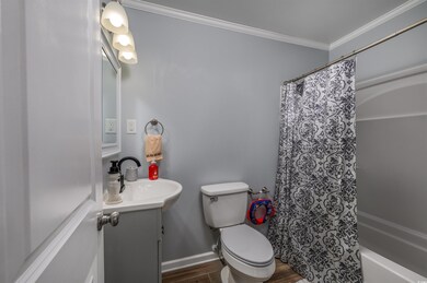 Full bathroom with toilet, shower / bath combo wit