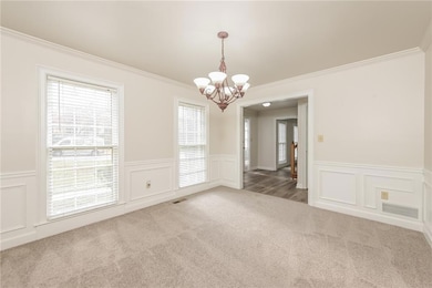 Empty room with crown molding, a notable chandelie