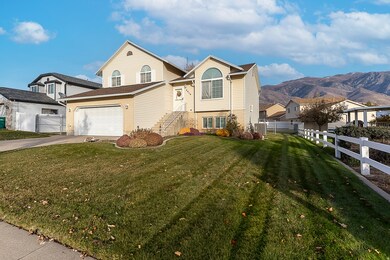 View of front of home featuring a garage, driveway, and stairs