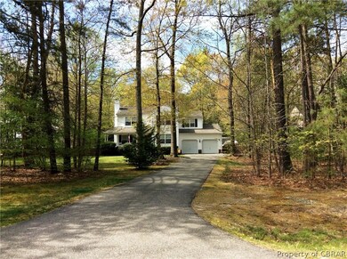 The long, paved driveway sets the house back from