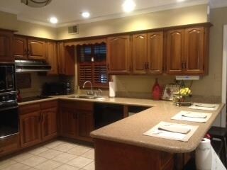 functional kitchen with quartz counter tops and lo