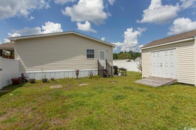 Rear view of house with a yard