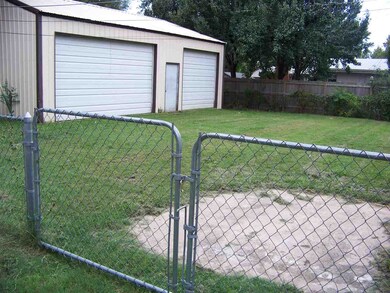 Extra parking pad leads to double gate for access 